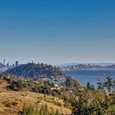 an aerial view of a house with a garden and lake view