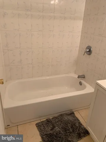 a bathroom with a shower and a bath tub