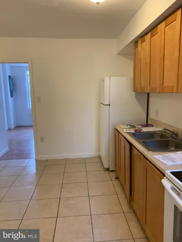 a kitchen with a sink a vanity and a stove