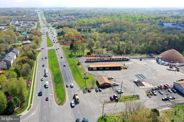 an aerial view of multiple houses with yard
