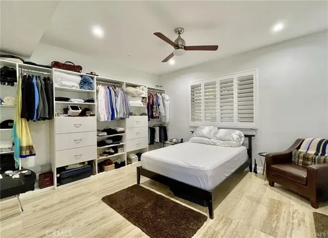 a bedroom with a bed and a couch