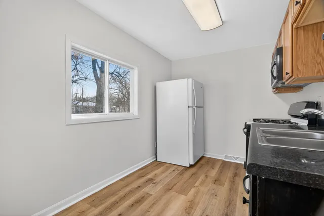 a view of an empty room with a fireplace