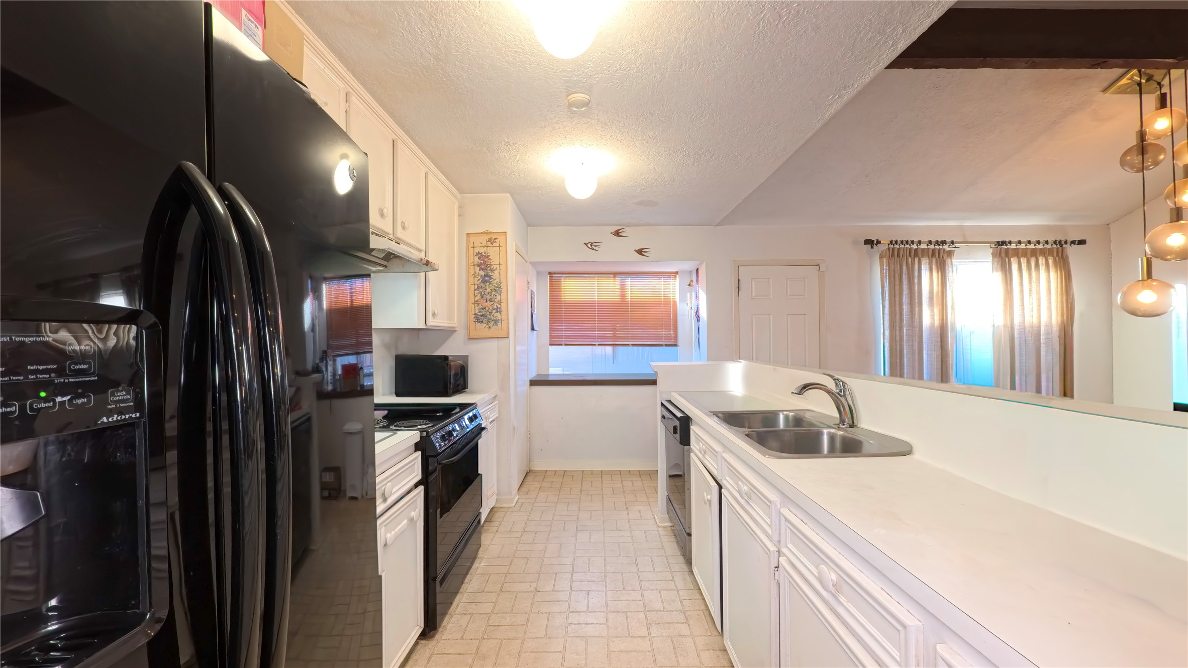 8650 Maplecrest Drive Houston, TX 77099 - Photo 8 of 15 a kitchen with a sink and a refrigerator