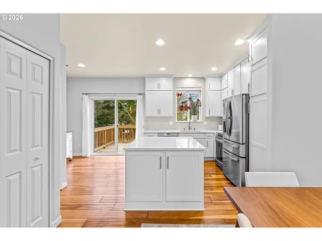 a kitchen with stainless steel appliances granite countertop a refrigerator sink and cabinets