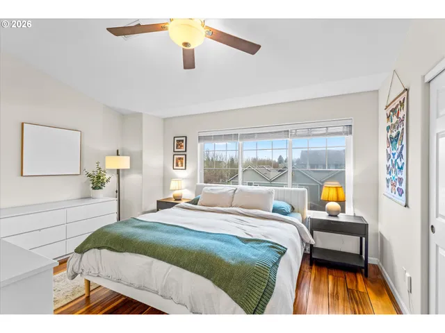 a bedroom with a bed and a large window