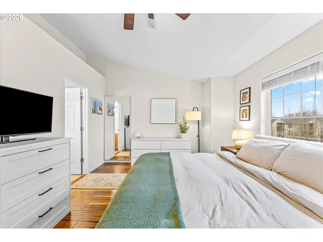 a bedroom with a bed and a flat screen tv