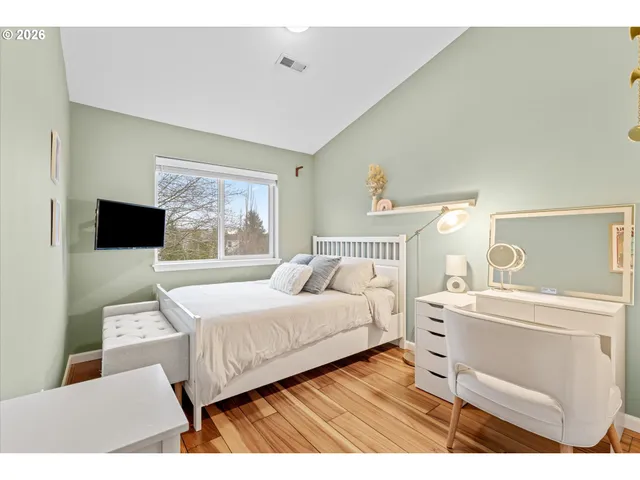 a bedroom with a bed and a desk