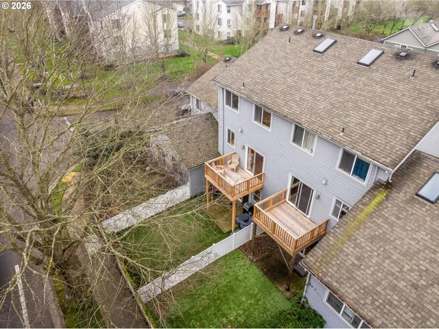 a aerial view of a house with a yard and potted plants