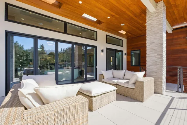 a kitchen with granite countertop a stove and white cabinets
