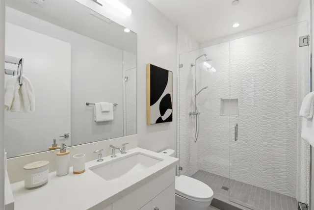 a bathroom with a sink mirror toilet and bathtub