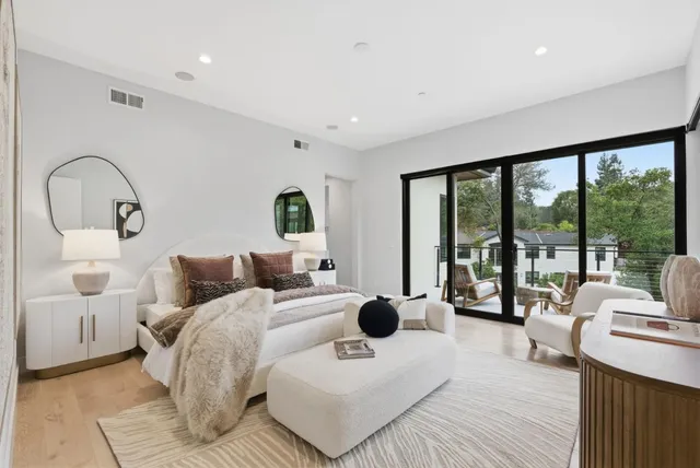a bedroom with two beds and a large window