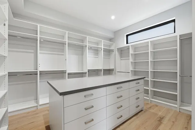 a living room with fireplace furniture large windows and a flat screen tv