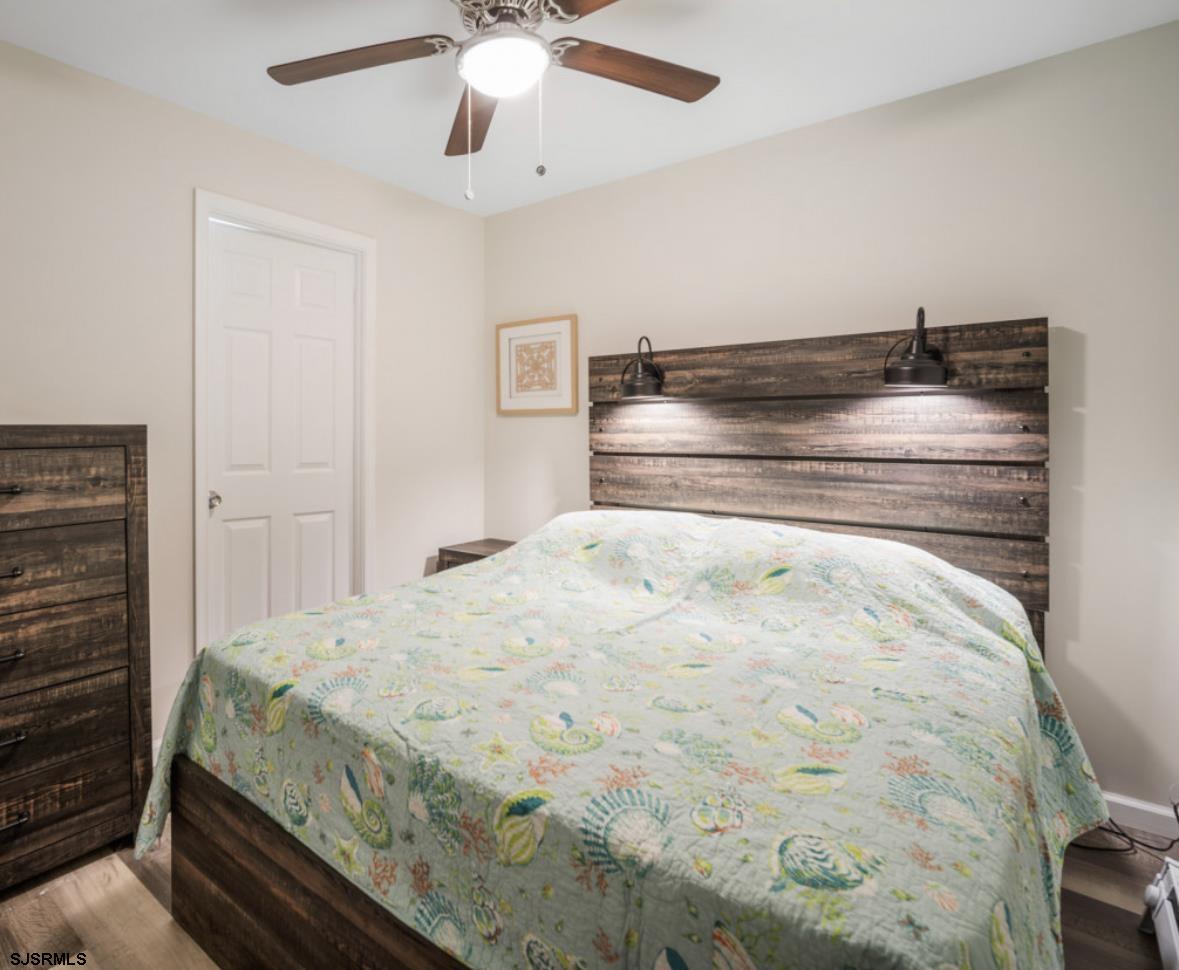 207 13th Street North Brigantine, NJ 08203 - Photo 13 of 44 a bedroom with a bed and a chandelier