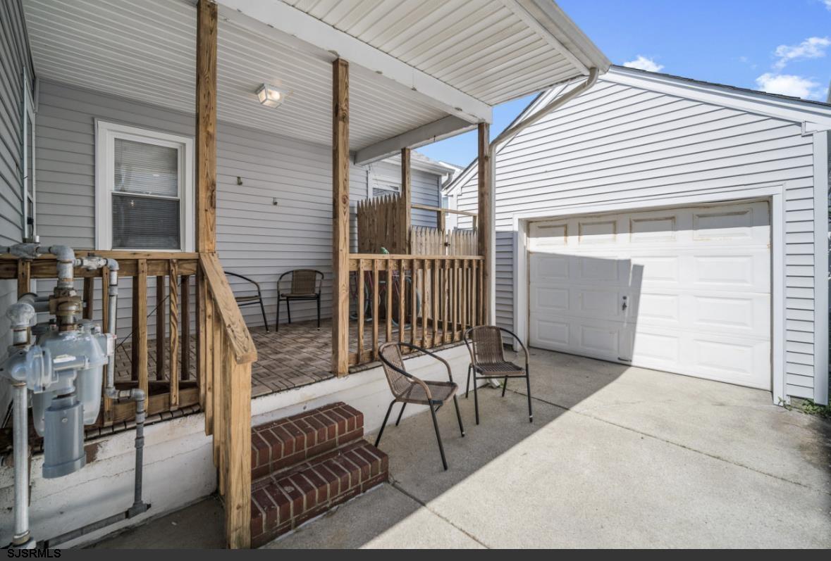 207 13th Street North Brigantine, NJ 08203 - Photo 17 of 44 a view of balcony with two chairs and a barbeque