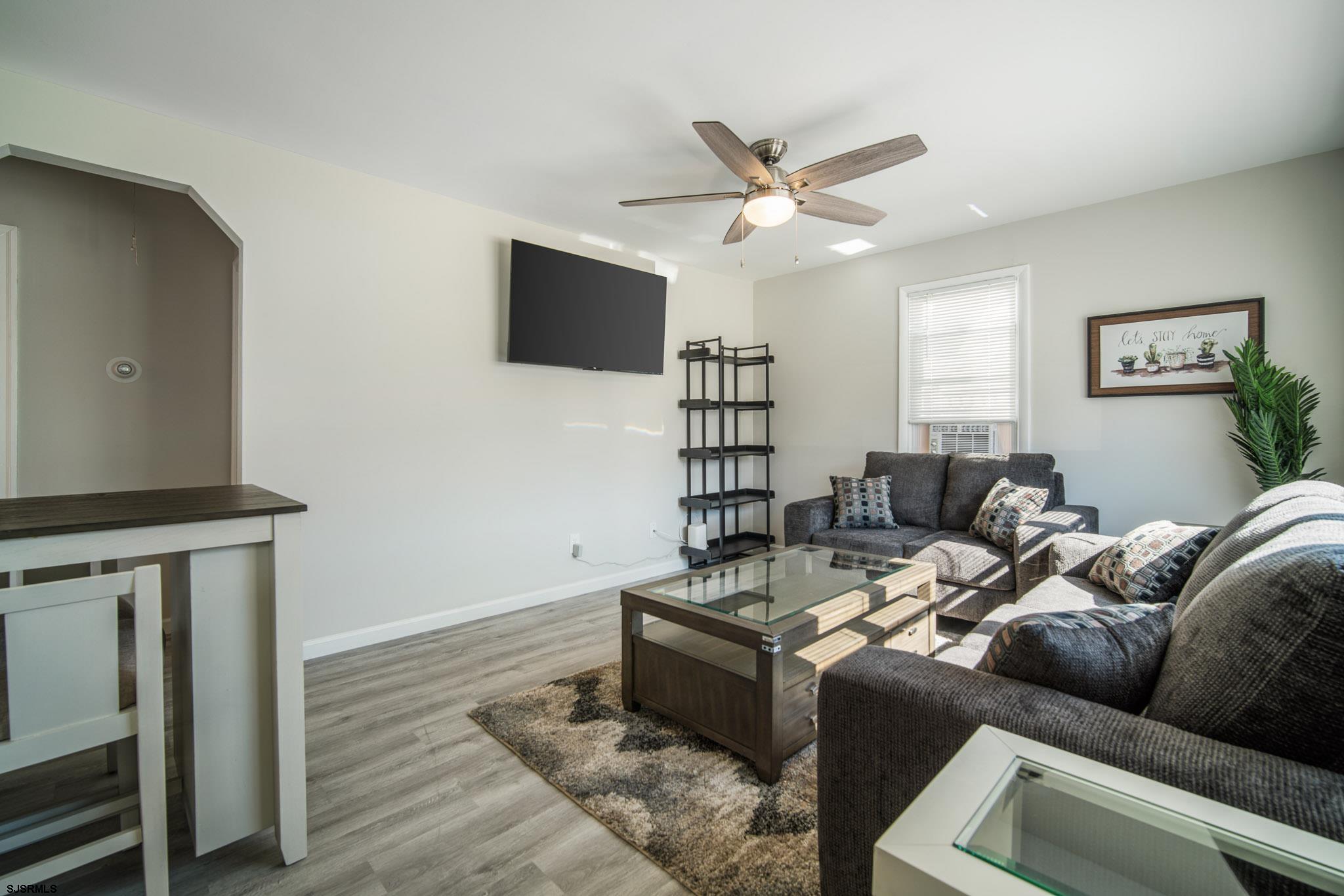 207 13th Street North Brigantine, NJ 08203 - Photo 23 of 44 a living room with furniture and a flat screen tv