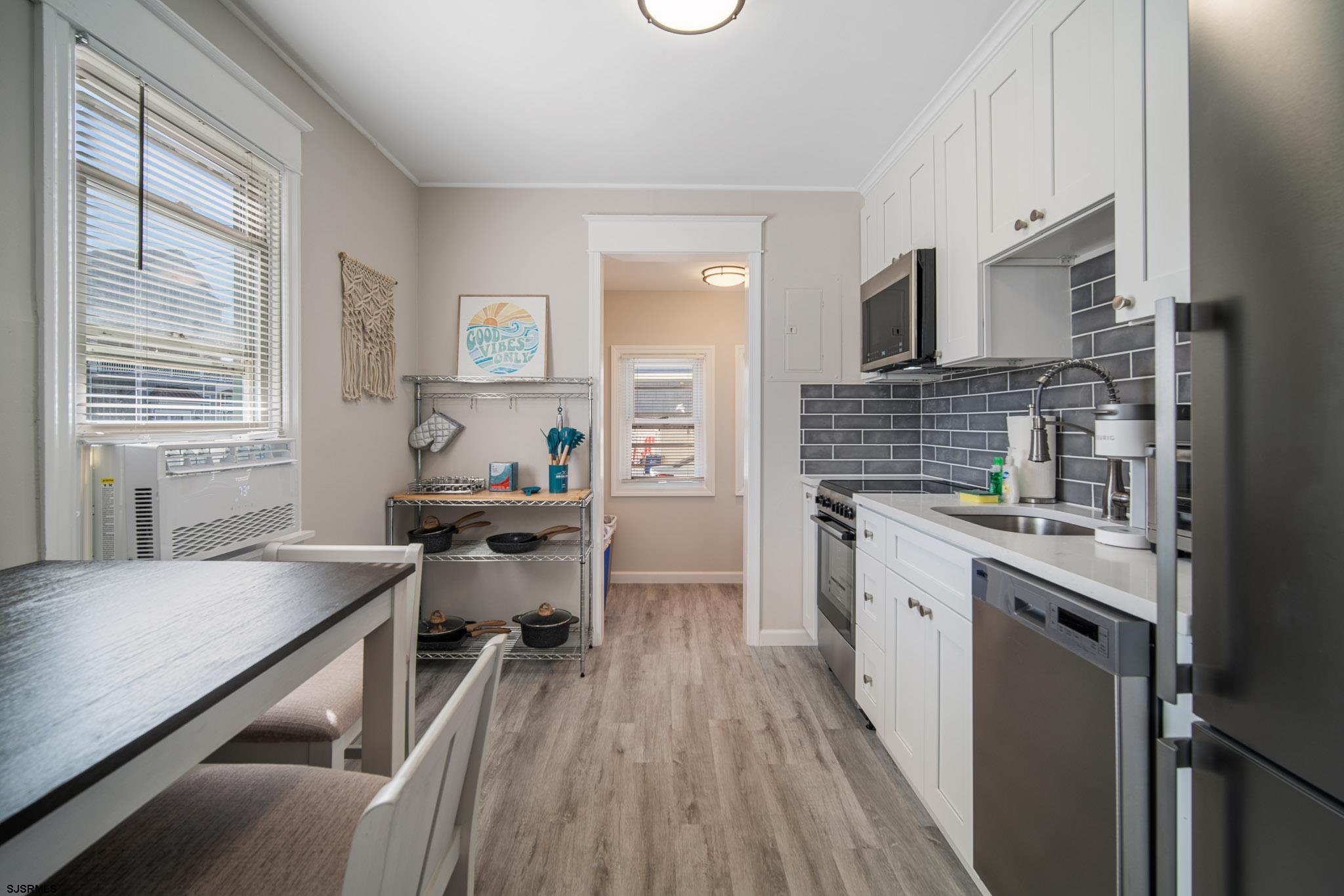 207 13th Street North Brigantine, NJ 08203 - Photo 28 of 44 a kitchen with a sink stove and cabinets