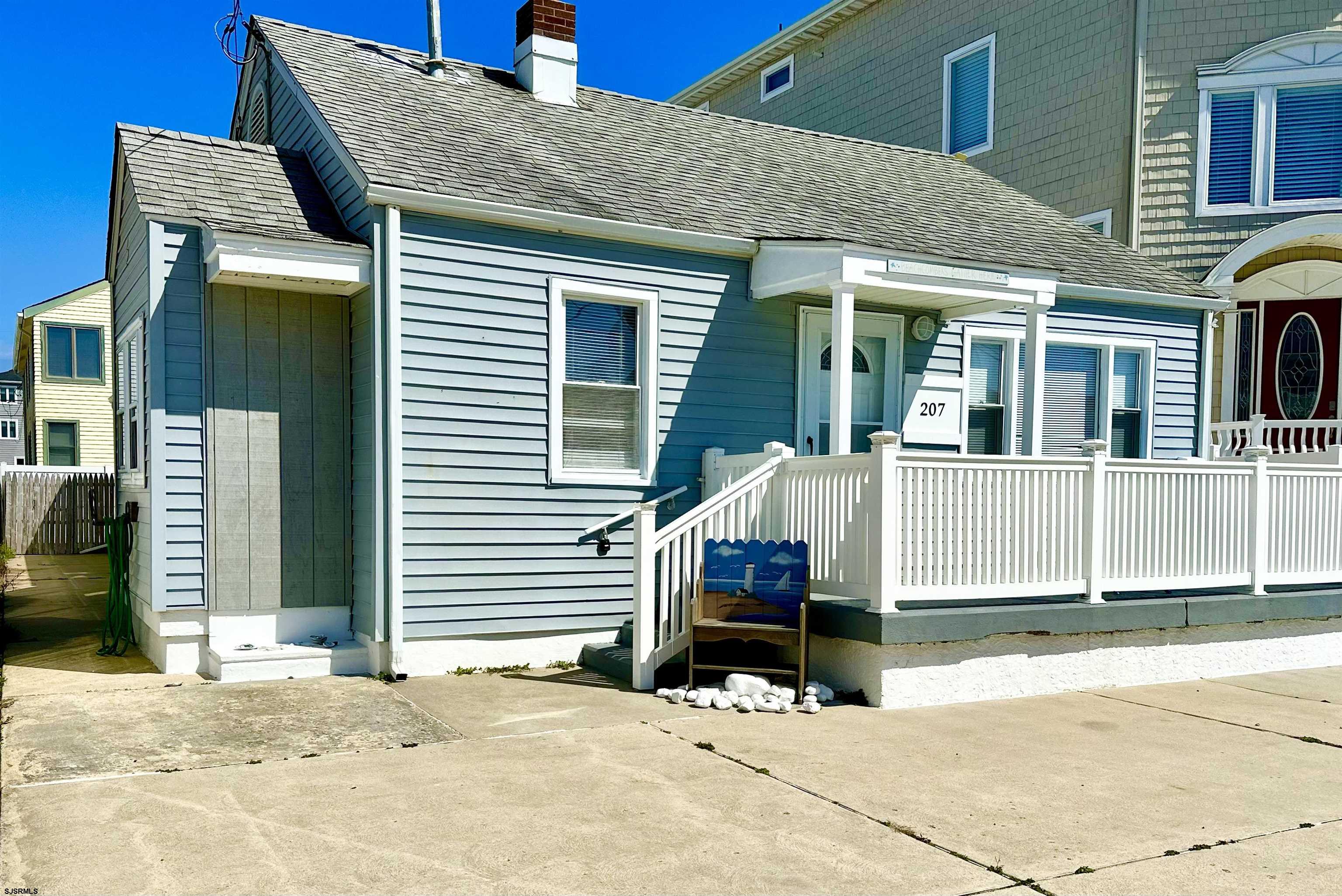 207 13th Street North Brigantine, NJ 08203 - Photo 3 of 44 a view of a house with wooden fence