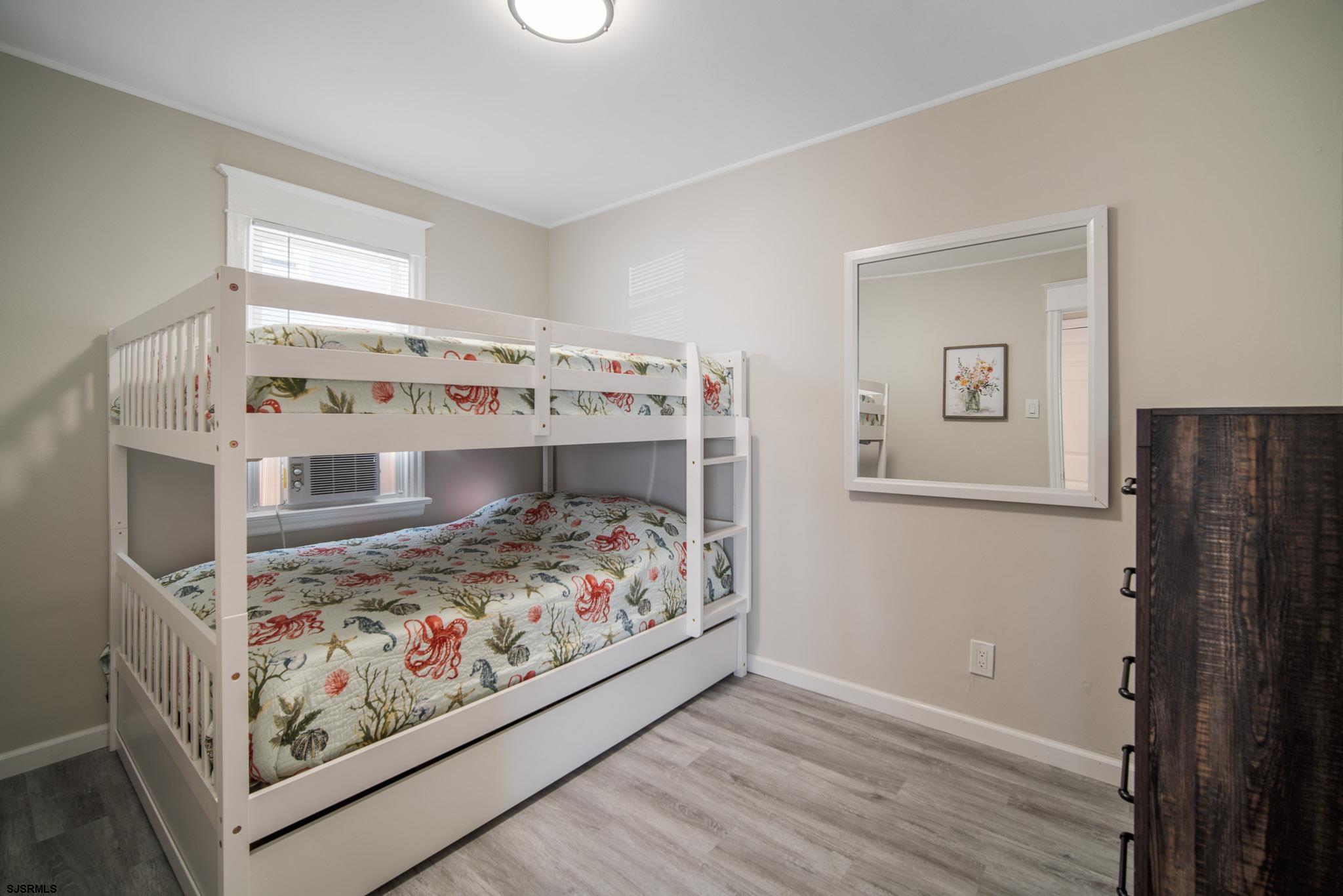 207 13th Street North Brigantine, NJ 08203 - Photo 33 of 44 a bedroom with bed and wooden floor
