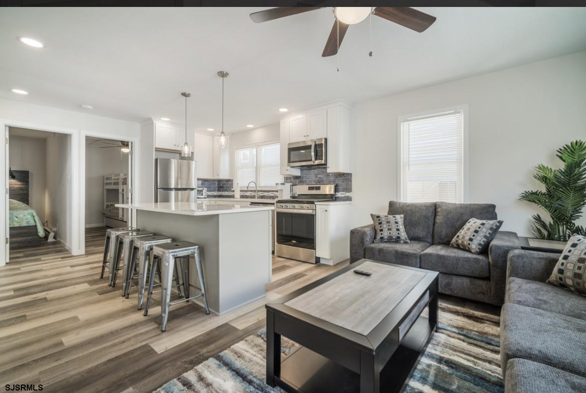 207 13th Street North Brigantine, NJ 08203 - Photo 5 of 44 a living room with a couch and chandelier
