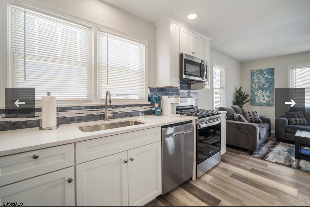 207 13th Street North Brigantine, NJ 08203 - Photo 7 of 44 a kitchen with a sink stove top oven and microwave