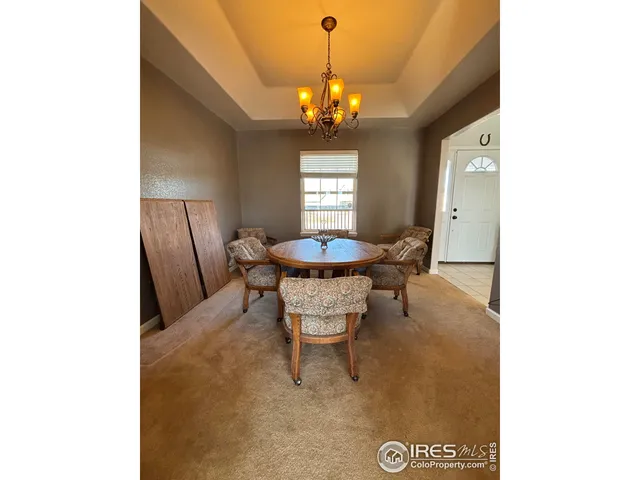 a dining room with a table and chairs