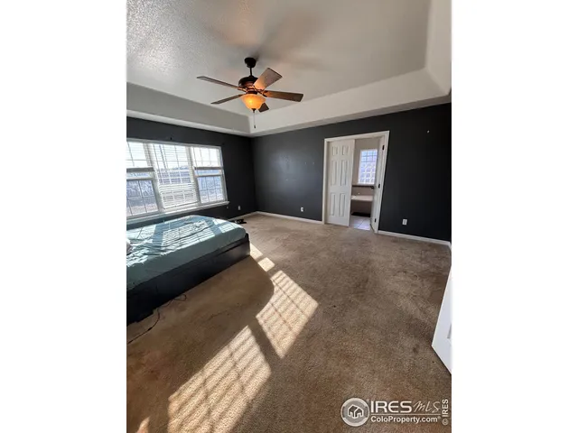 a view of a livingroom with a ceiling fan and window