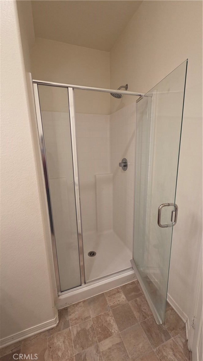5321 Declan Street Riverside, CA 92504 - Photo 13 of 34 a bathroom with a glass door shower