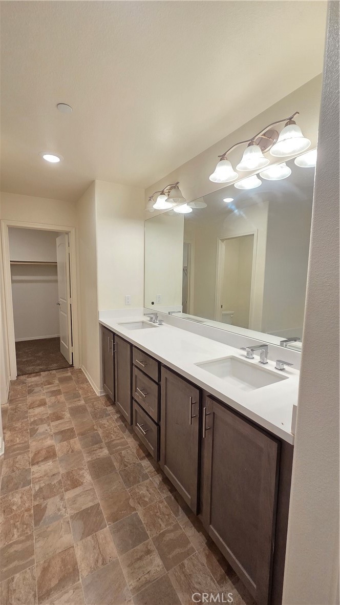 5321 Declan Street Riverside, CA 92504 - Photo 24 of 34 a bathroom with a double vanity sink and a mirror