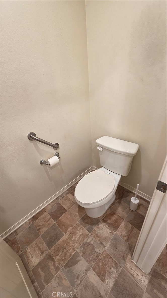 5321 Declan Street Riverside, CA 92504 - Photo 27 of 34 a white toilet sitting next to a white wall