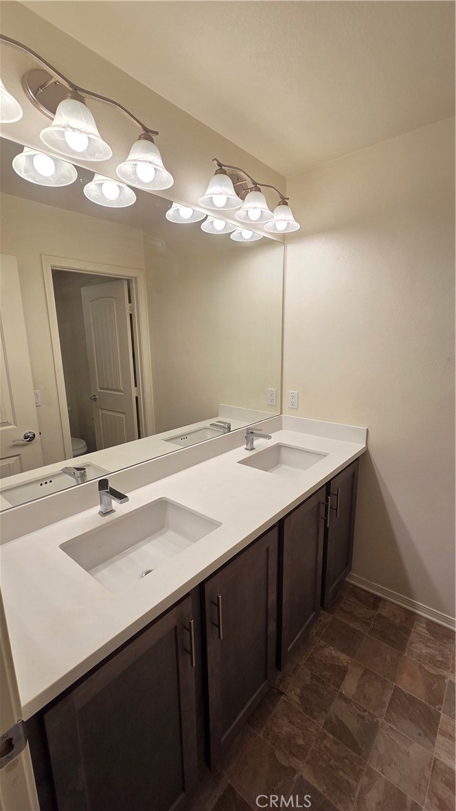 5321 Declan Street Riverside, CA 92504 - Photo 32 of 34 a bathroom with a sink and a mirror