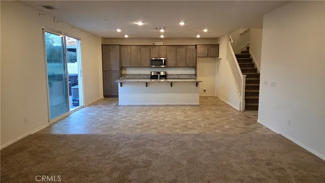 a view of kitchen with sink microwave and refrigerator