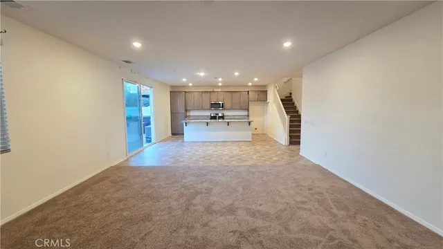a view of an empty room and a window