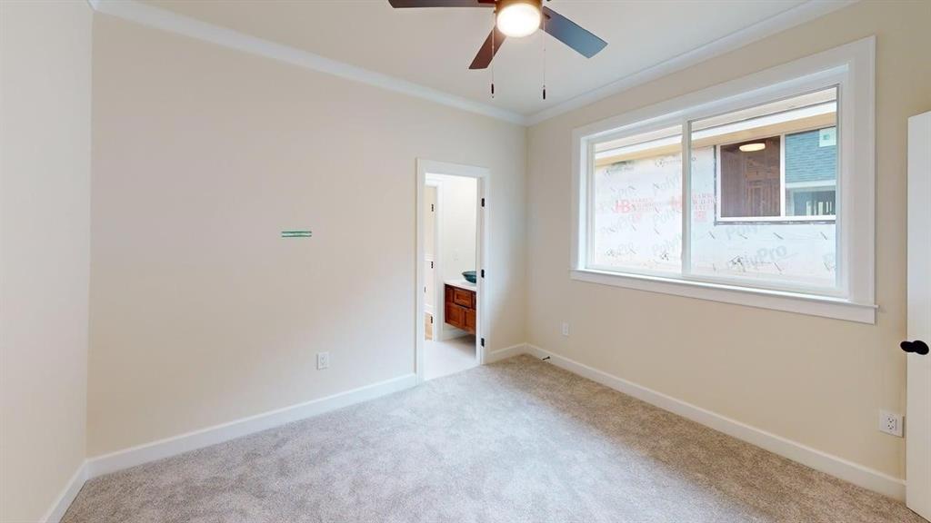 2509 Windmill Lane Longview, TX 75601 - Photo 25 of 35 Unfurnished bedroom with carpet flooring, ensuite bathroom, and crown molding
