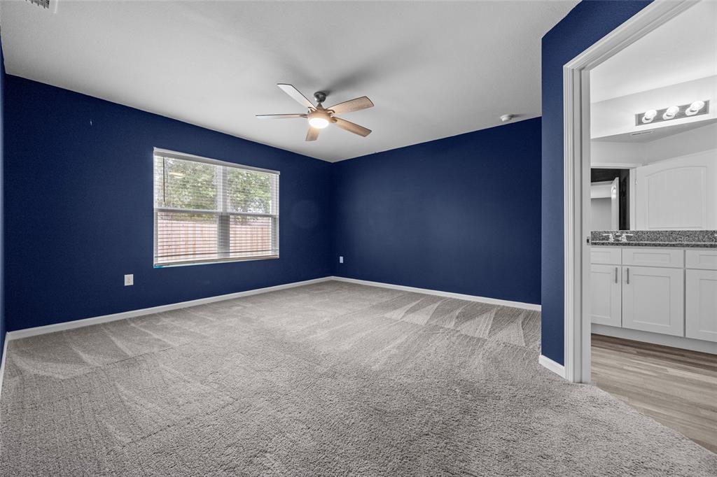 20105 Northwest 247th Street High Springs, FL 32643 - Photo 12 of 26 an empty room with windows and fan