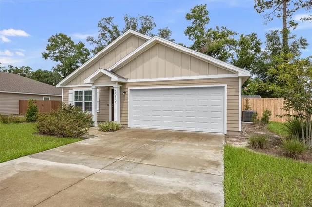 a view of backyard of house and trees