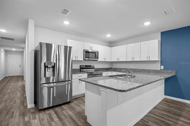a kitchen with a refrigerator sink and microwave