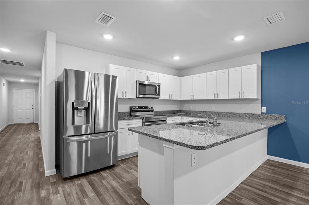 20105 Northwest 247th Street High Springs, FL 32643 - Photo 5 of 26 a kitchen with a refrigerator sink and microwave