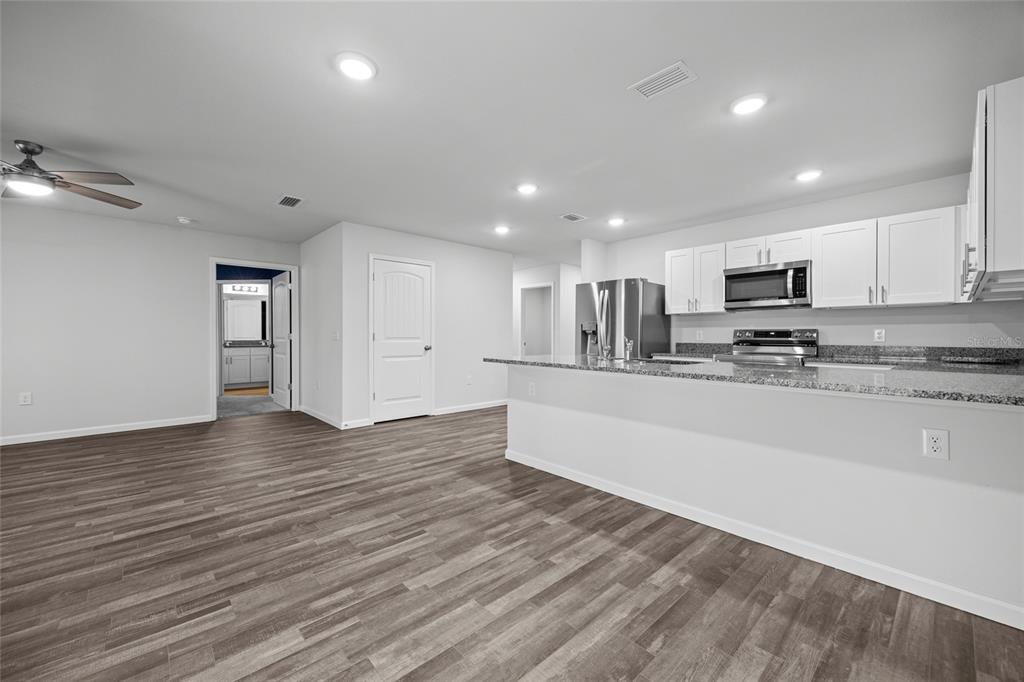 20105 Northwest 247th Street High Springs, FL 32643 - Photo 8 of 26 a view of kitchen with stainless steel appliances granite countertop a refrigerator and a stove top oven