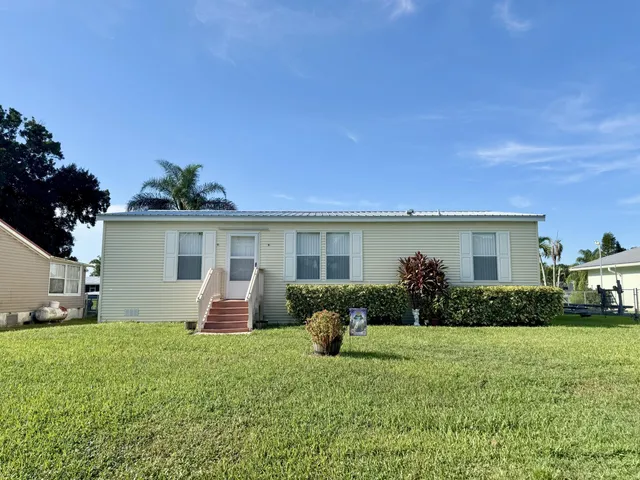 a front view of house with yard and outdoor seating