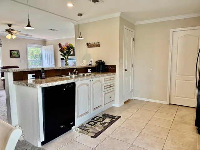 a kitchen with a stove a sink and a refrigerator