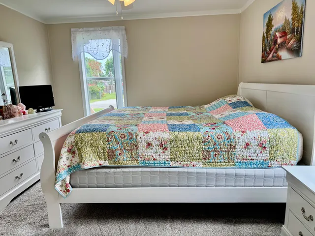 a bedroom with a bed and a window