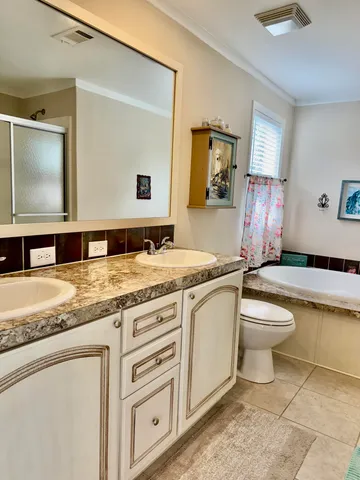 a bathroom with a granite countertop sink toilet and a mirror