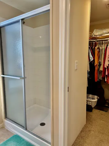 a bathroom with a glass shower door