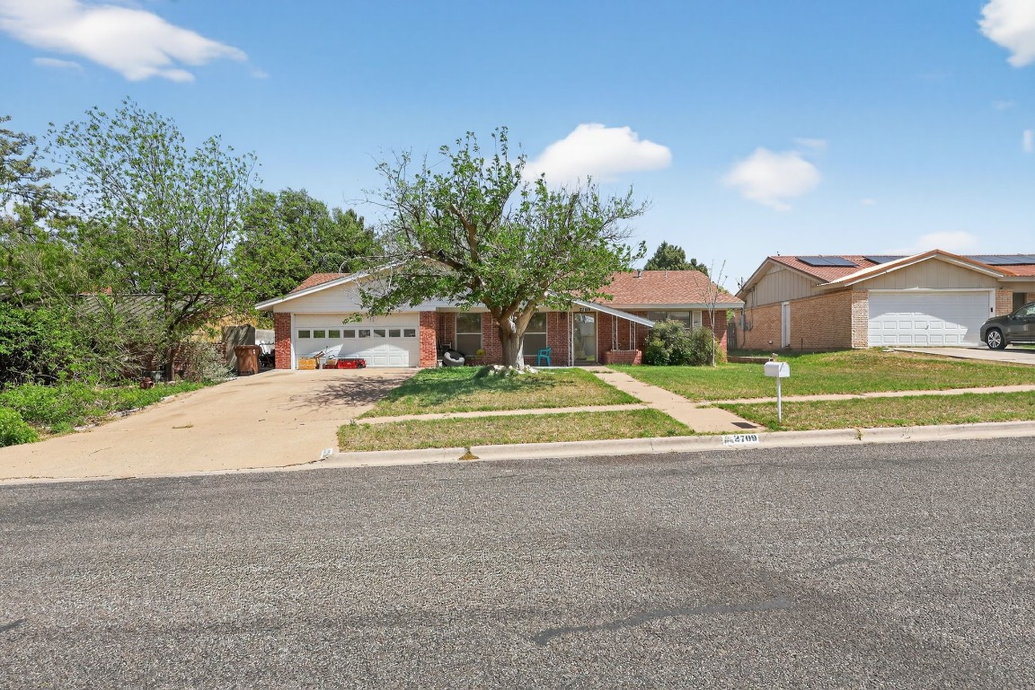 a view of a house with a yard and a car park fire pit