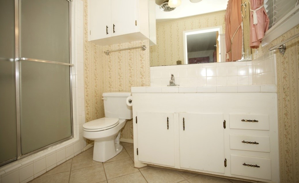 2709 Rebecca Drive Big Spring, TX 79720 - Photo 12 of 16 a bathroom with a sink a toilet and shower