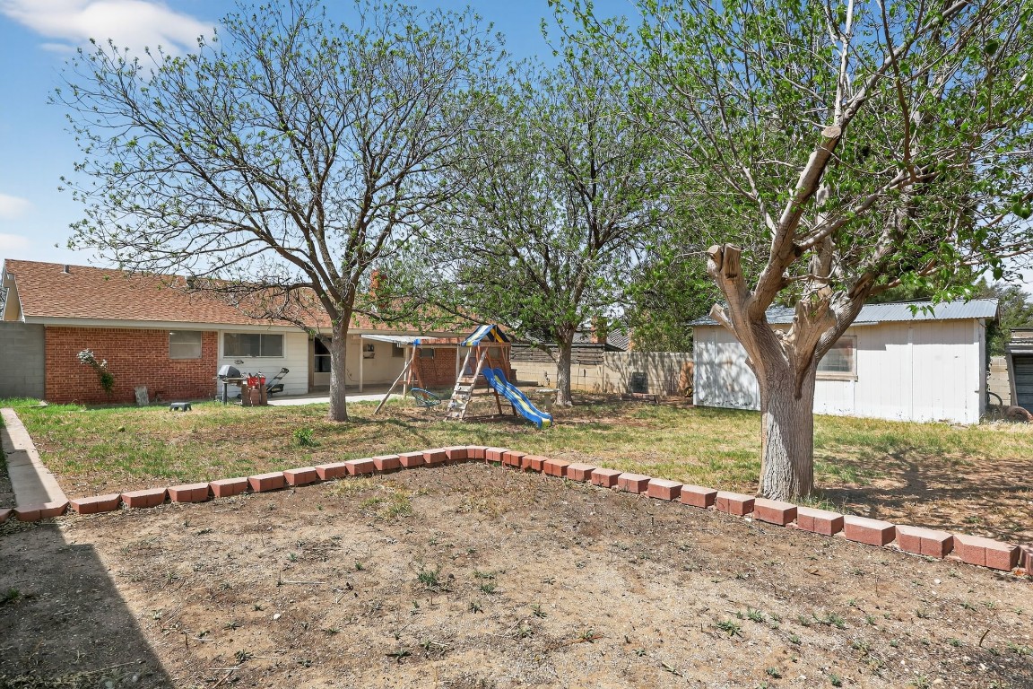 2709 Rebecca Drive Big Spring, TX 79720 - Photo 13 of 50 a view of a yard with a large tree