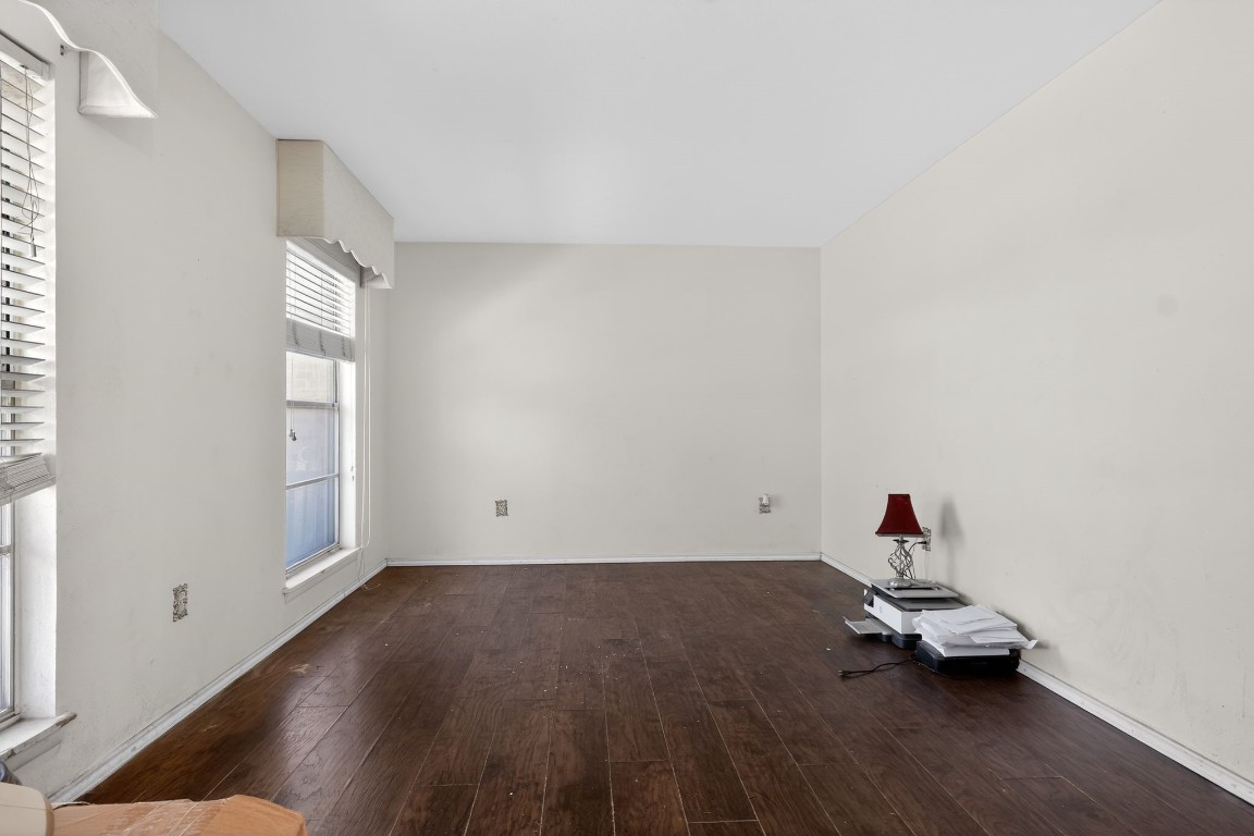 2709 Rebecca Drive Big Spring, TX 79720 - Photo 17 of 50 a room with a wooden floor and a window