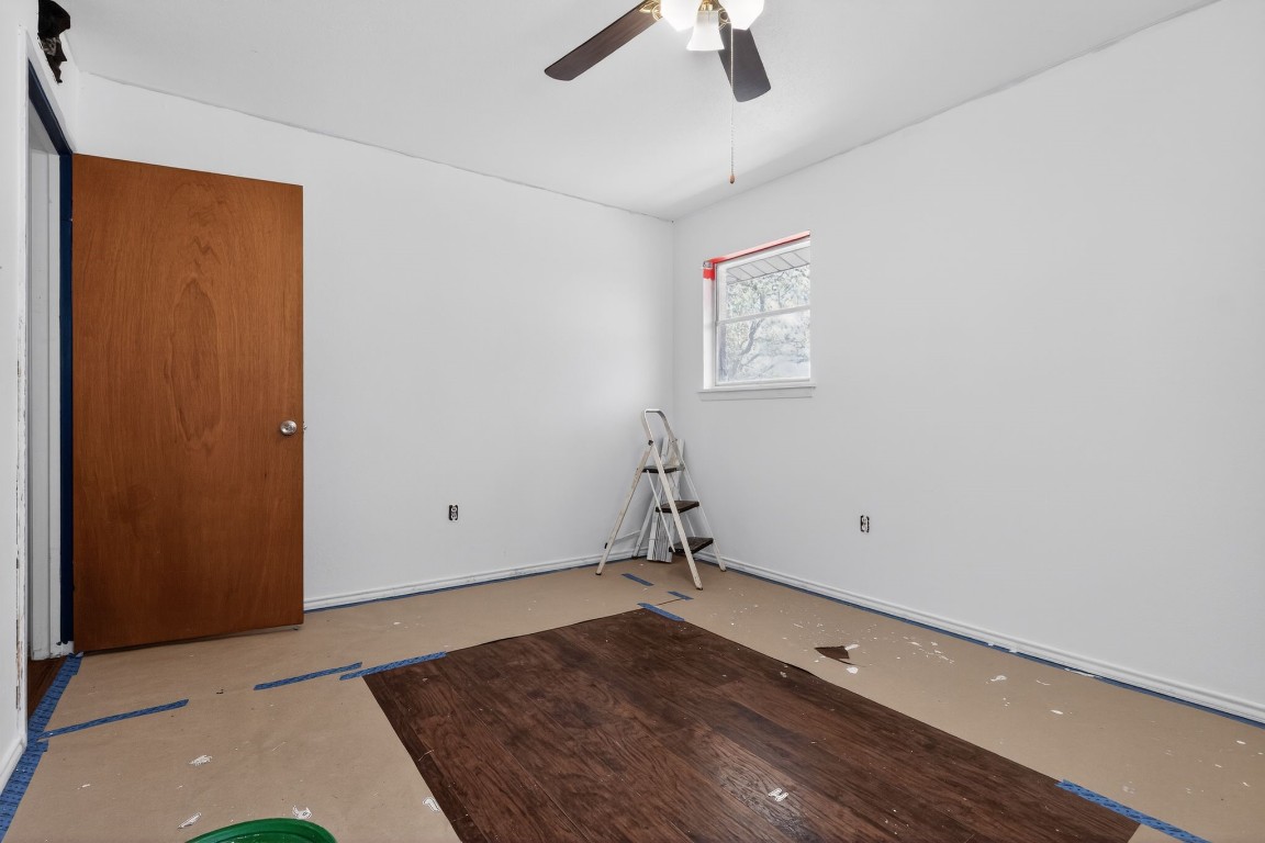 2709 Rebecca Drive Big Spring, TX 79720 - Photo 19 of 50 an empty room with a ceiling fan and wooden floor
