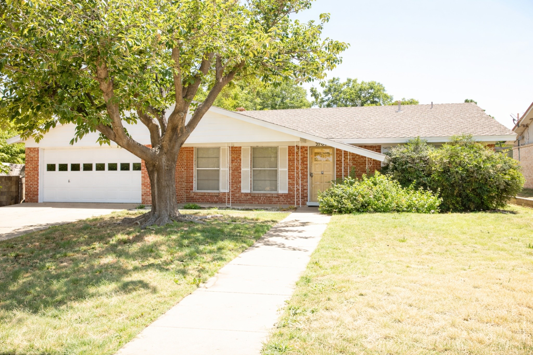 2709 Rebecca Drive Big Spring, TX 79720 - Photo 2 of 16 a front view of a house with a yard and garage