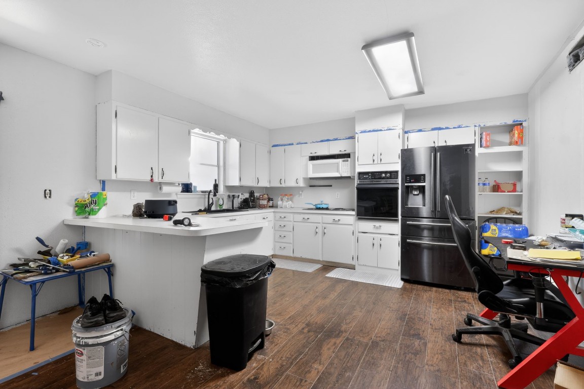 2709 Rebecca Drive Big Spring, TX 79720 - Photo 29 of 50 a kitchen with a refrigerator a stove a sink and cabinets